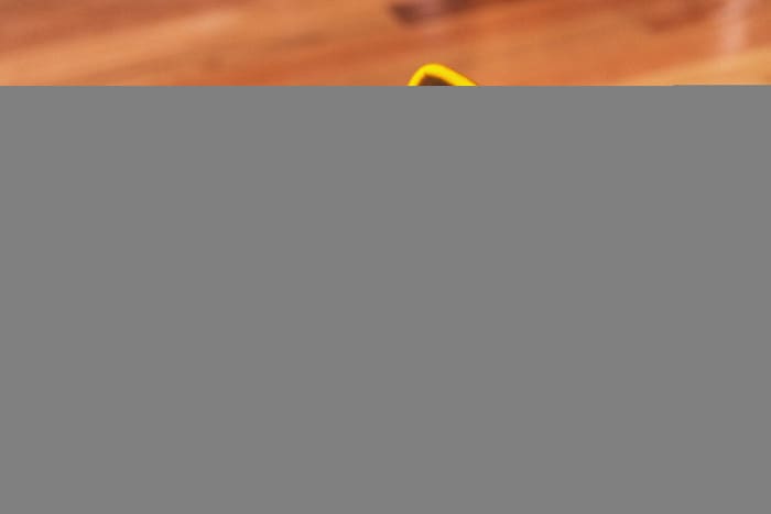 Side view of Damian Lillard's yellow and black adidas sneakers.